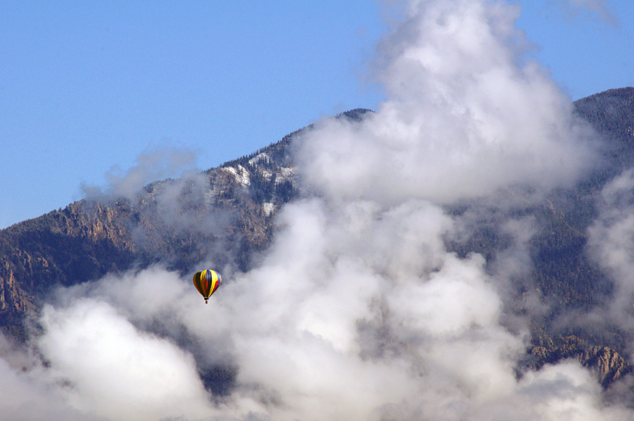 hot-air balloon passing by Taos mountain