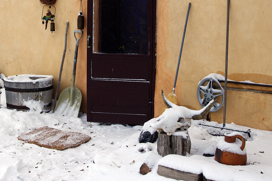 front door of an old adobe in the snow