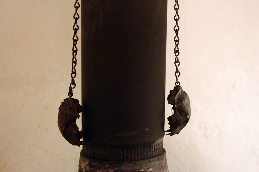 bronze cat skulls hanging on stovepipe