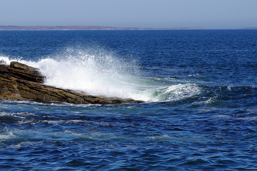wave crashing on the rocks on the coast of Maine
